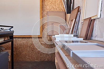 Frames on a workbench in picture framing studio Stock Photo