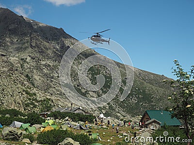 France, Corsica, Corsician Alps, June 19, 2017: helicopter dropping off supplies for mountain camp Refuge de Pietra Piana on Editorial Stock Photo