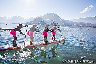 19.01.2019 - France Lake Annecy GlaGla Race 2019. SUP paddlers girl team is participating in race in France Alps lake Editorial Stock Photo
