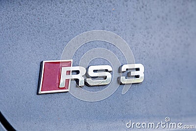 France Lyon 2019-06-20 closeup brand logo of premium sports car dark gray hatchback Audi RS 3, low profile tires, cast disk, red Editorial Stock Photo