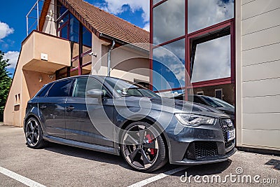 France Lyon 2019-06-20 closeup side view of premium sports car dark gray hatchback Audi RS 3, low profile tires, cast disk; red Editorial Stock Photo