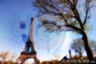 France, Paris, Eiffel Tower in a rainy day with draw heart on wet glass Stock Photo
