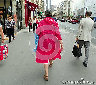 France, Paris, Rue de Rennes, woman in red balloon coat and hat Editorial Stock Photo