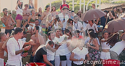 France, St. Tropez, 15 August 2017: The richest people arrange a shower of champagne, people hide from the rain of stock footage France, St. Tropez, 15 August 2017: The richest people arrange a shower of champagne, people hide from the rain of stock footage