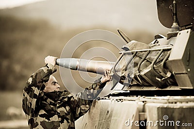 France, the training center of the foreign legion - circa, 2011. The legionnaire submits a combat charge to the tank. Editorial Stock Photo