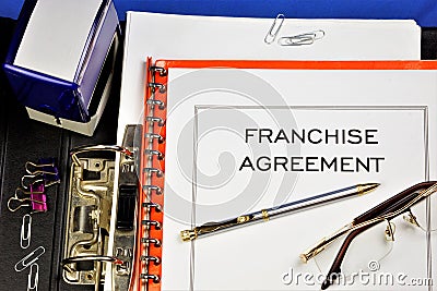 Franchise agreement. A commercial concession is a relationship between market entities where one party transfers to the other Stock Photo