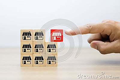 Businessman hand choose wooden blog with franchise marketing icons Store Stock Photo