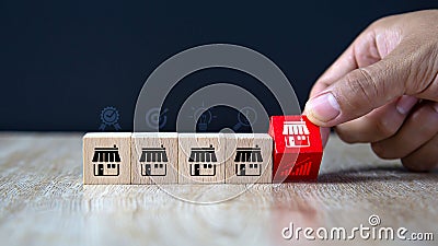 Close-up hand choose cube wooden toy block stack with graph icon for best quality franchises business growth and branch Stock Photo