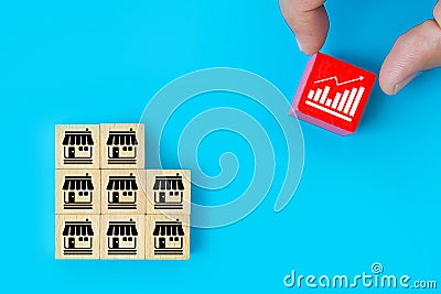 Franchise or franchising, Hand choose graph on cube wooden toy block stack on franchises business store icon for growth and Stock Photo
