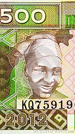 500 Francs banknote, Bank of Guinea. National currency. Fragment: Woman, Headwear Stock Photo