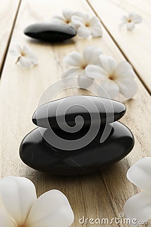 Frangipani flower and black stone, zen spa on wood Stock Photo