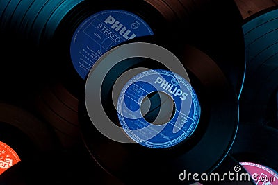 Frankfurt, Germany - April 2021: close-up of black vinyl record of Philips recording studio, color lighting, analog retro music Editorial Stock Photo