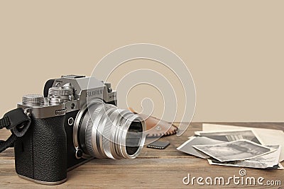 FRANKFURT, GERMANY - JUNE 2020: FUJIFILM XT4 digital camera with Fujinon lens, vintage photographs on old wood background, Editorial Stock Photo