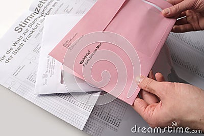 Frankfurt, Germany - March 2021: Male hands hold envelopes with a ballot paper for the Hessian local elections Frankfurt on March Editorial Stock Photo