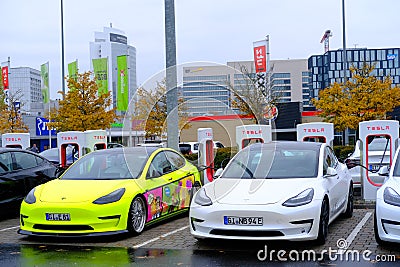 Frankfurt, Germany, October 2021: many Tesla light electric cars replenish battery at charging station, alternative energy Editorial Stock Photo