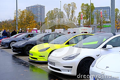 Frankfurt, Germany, October 2021: many Tesla light electric cars replenish battery at charging station, alternative energy Editorial Stock Photo