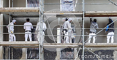 Painter and plasterer work on a scaffold to renovate an old wall Editorial Stock Photo