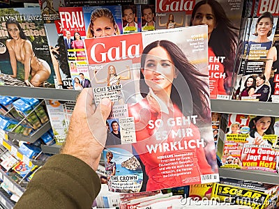 POV male hand buying latest newspaper magazine Gala magazine with Meghan Markle Editorial Stock Photo