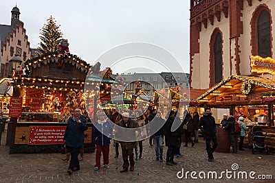 FRANKFURT AM MAIN, GERMANY - December 2018: people walk around Frankfurt Square during the Christmas market, buy sweets, ride on Editorial Stock Photo