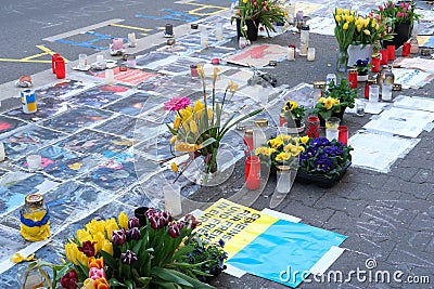 Frankfurt - March 2022: memorial day for the dead, flowers lie on ground, mourning candles burning for dead, an anti-war rally Editorial Stock Photo