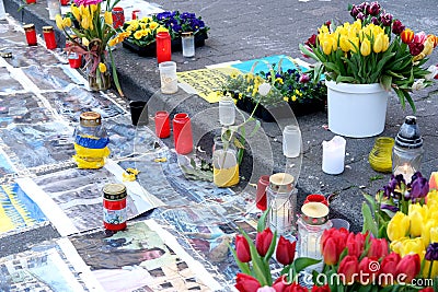 Frankfurt - March 2022: memorial day for the dead, flowers lie on ground, mourning candles burning for dead, an anti-war rally Editorial Stock Photo