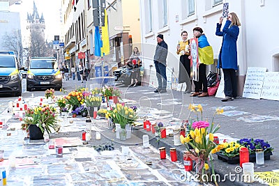 Frankfurt - March 2022: memorial day for the dead, flowers lie on ground, mourning candles burning for dead, an anti-war rally Editorial Stock Photo