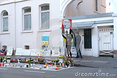 Frankfurt - March 2022: people support Ukraine, flowers lie on ground, mourning candles burning for dead, an anti-war rally near Editorial Stock Photo