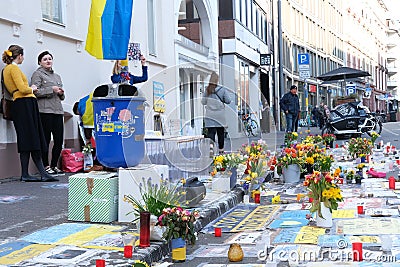 Frankfurt - March 2022: people support Ukraine, flowers lie on ground, mourning candles burning for dead, an anti-war rally near Editorial Stock Photo