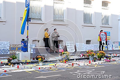 Frankfurt - March 2022: people support Ukraine, flowers lie on ground, mourning candles burning for dead, an anti-war rally near Editorial Stock Photo