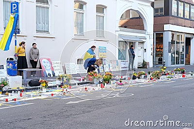 Frankfurt - March 2022: people support Ukraine, flowers lie on ground, mourning candles burning for dead, an anti-war rally near Editorial Stock Photo