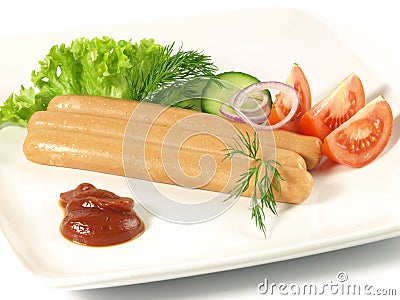 Frankfurters with ketchup and vegetables Stock Photo
