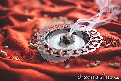 Frankincense burning on a hot coal. aromatic resin, used for religious rites, incense and perfumes, incense smoke Stock Photo