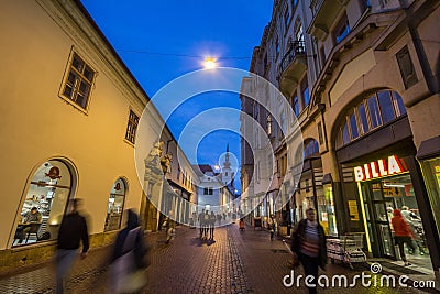 Frantiskanske ulice street in the city center of Brno, surrounded by boutiques, at night, with Kostel svate mari magdaleny church Editorial Stock Photo