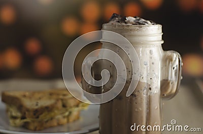 Frappuccino with chocolate pieces in cactus shaped glass Stock Photo