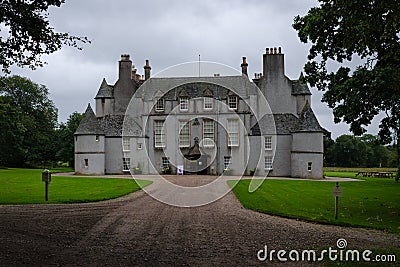 View of Leith Hall Castle among the trees on a cloudy day, Scotland, United Kingdom Stock Photo