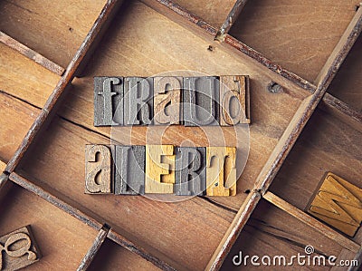 Fraud Alert in wooden letterpress Stock Photo