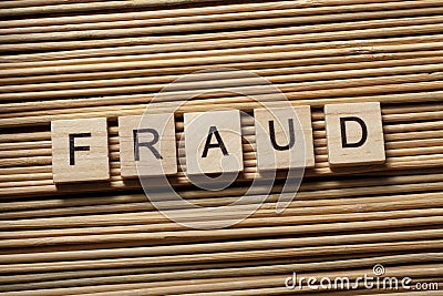 FRAUD word written on wooden cubes. Finance Concept. Money Stock Photo