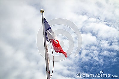 Frazzled flag of France waving in the wind Stock Photo