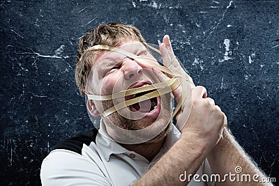 Freak man with rubber on his face Stock Photo