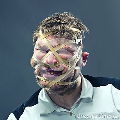 Freak man with rubber on his face Stock Photo