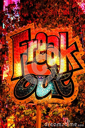 Freak Out neon sign, in vibrant orange, red, yellow and blue colours Stock Photo