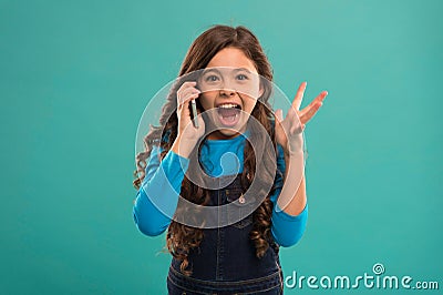 Freaking out. Modern gadget. Upbringing and development. Little girl call mobile phone blue background. Cute kid hold Stock Photo