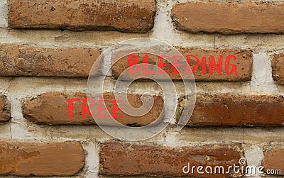 Free bleeding symbol. Concept words Free bleeding on beautiful brown bricks. Beautiful brick wall background. Beautiful brick wall Stock Photo