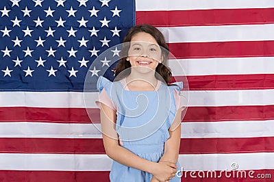 Free born and free bred. Carefree small child enjoying happy childhood. Happy little girl smiling on american flag decor Stock Photo