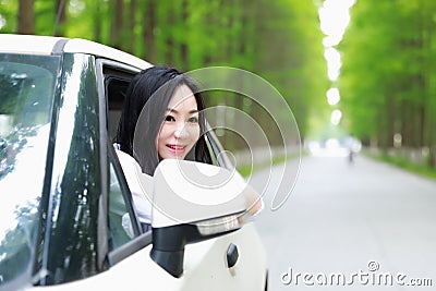 Free careless causual beauty sit on a white car parking on forest road in summer nature outdoor Stock Photo