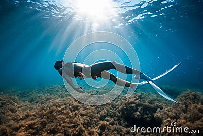 Free diver woman with white fins posing underwater. Freediving with young girl Stock Photo