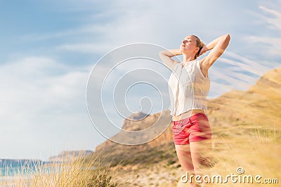 Free Happy Woman Enjoying Sun on Vacations. Stock Photo