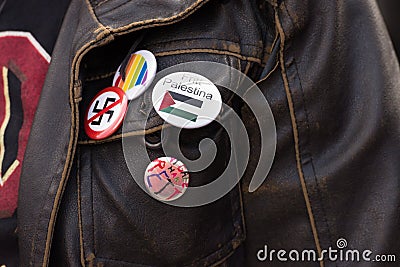 Free Palestine, Anti-Swastika, LGBTQ pins on activist jacket Editorial Stock Photo