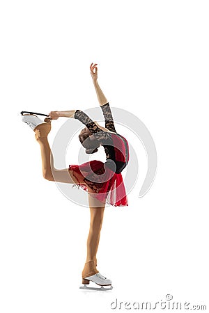 Portrait of little flexible girl, figure skater wearing stage attire posing isolated on white studio backgound. Concept Stock Photo