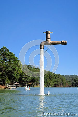 Free standing faucet floating over a lake Stock Photo